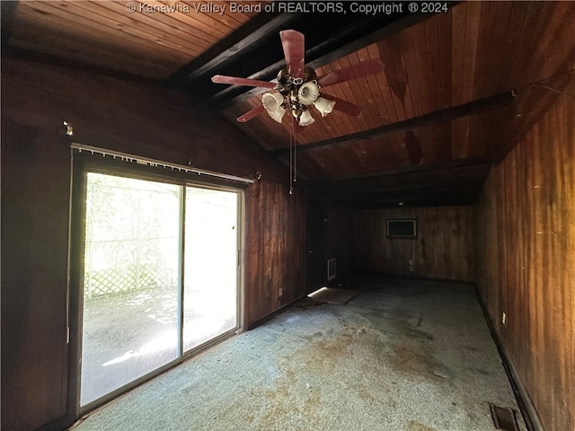 interior space with ceiling fan, lofted ceiling with beams, and wood walls