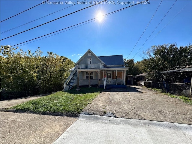 3962 39th St E, Nitro, WV 25143 - view of front of home featuring covered porch, stairway, metal roof, and driveway