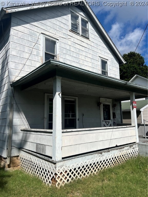 view of side of property with covered porch