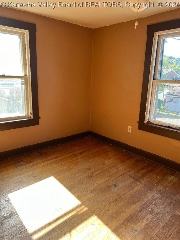 empty room with hardwood / wood-style flooring