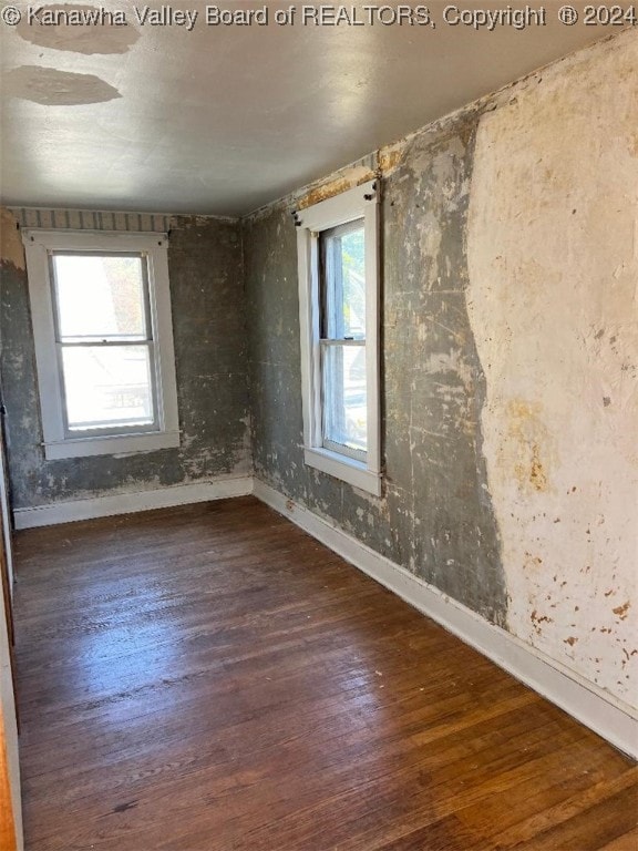 spare room featuring dark hardwood / wood-style flooring