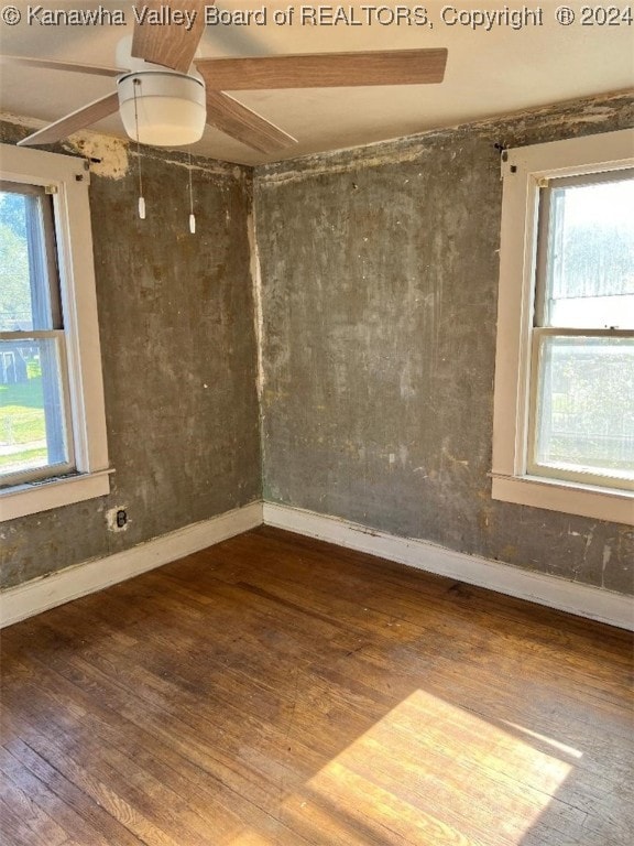 empty room with ceiling fan and hardwood / wood-style flooring