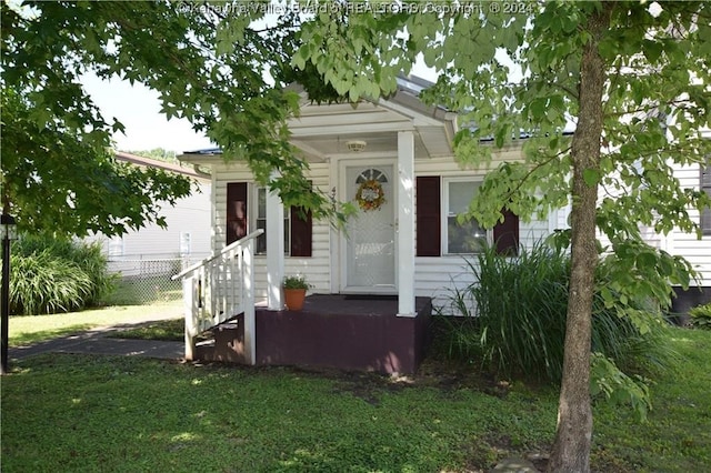 bungalow-style house with a front lawn