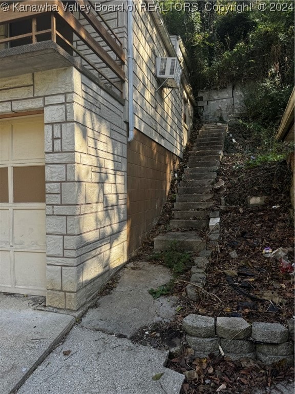 view of home's exterior with cooling unit and a garage