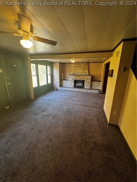 unfurnished living room with a fireplace, carpet flooring, and ceiling fan