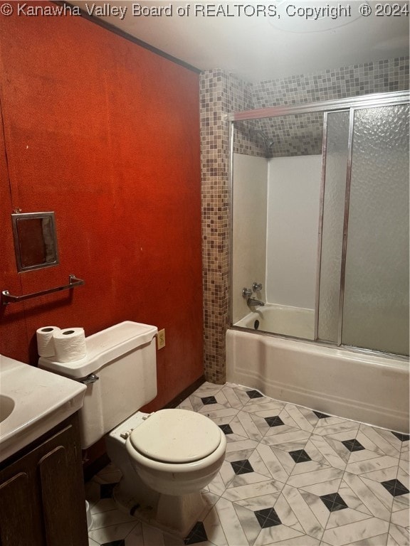 full bathroom featuring vanity, toilet, shower / bath combination with glass door, and tile patterned flooring