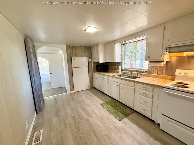 kitchen featuring light hardwood / wood-style flooring, backsplash, sink, white cabinetry, and white appliances