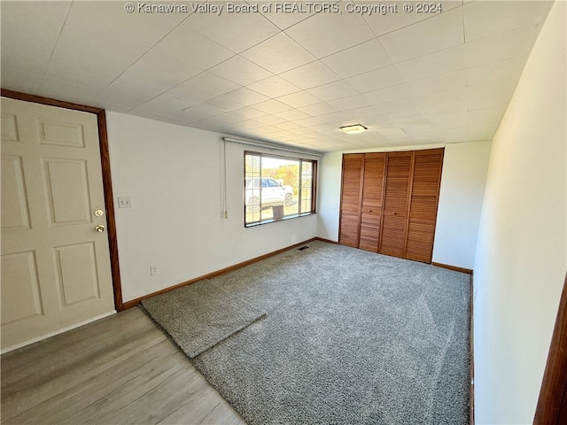 unfurnished bedroom with a closet and hardwood / wood-style flooring