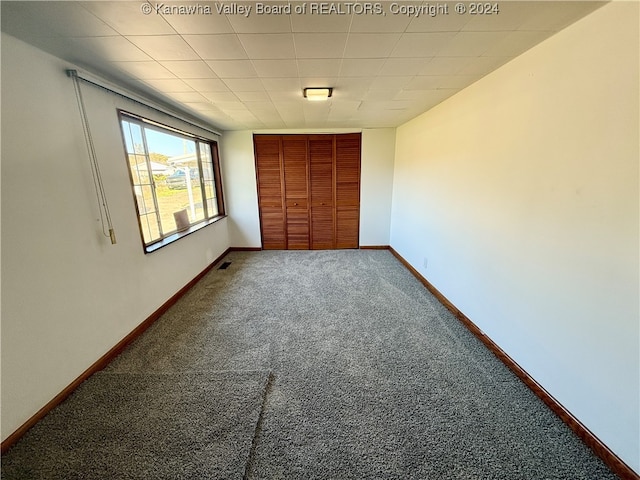 unfurnished bedroom featuring carpet and a closet