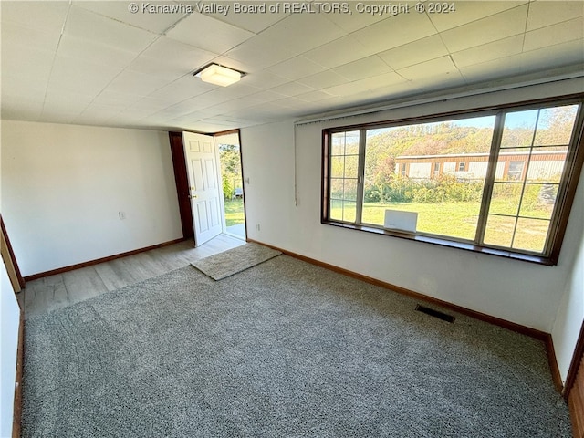 empty room with hardwood / wood-style flooring