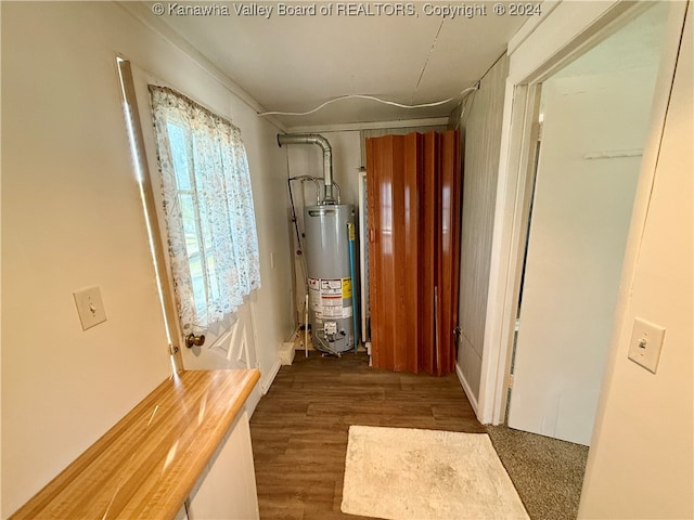 hallway featuring dark hardwood / wood-style flooring and gas water heater