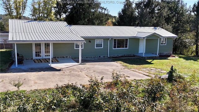 back of house featuring a patio and a lawn