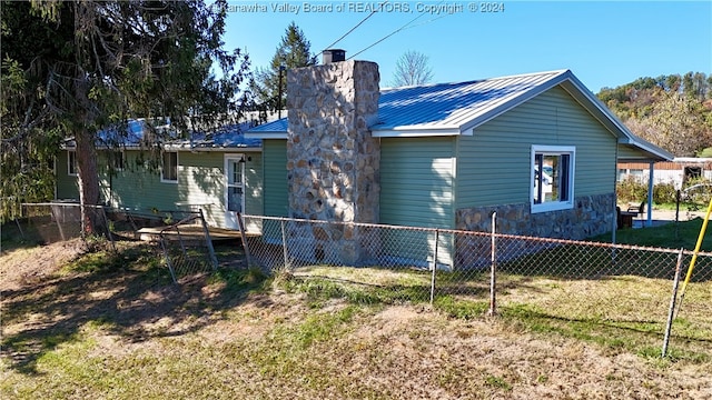 rear view of house featuring a lawn