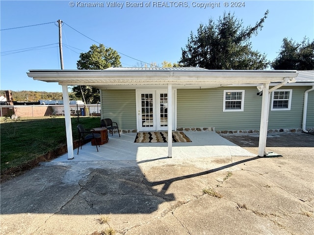 rear view of property featuring a patio area and french doors