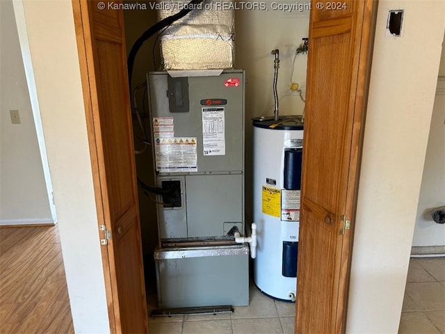 utility room featuring heating unit and water heater