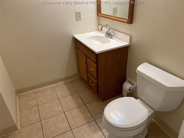 bathroom with vanity, toilet, and tile patterned floors