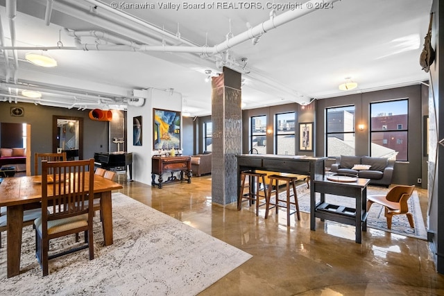 dining area featuring ornate columns