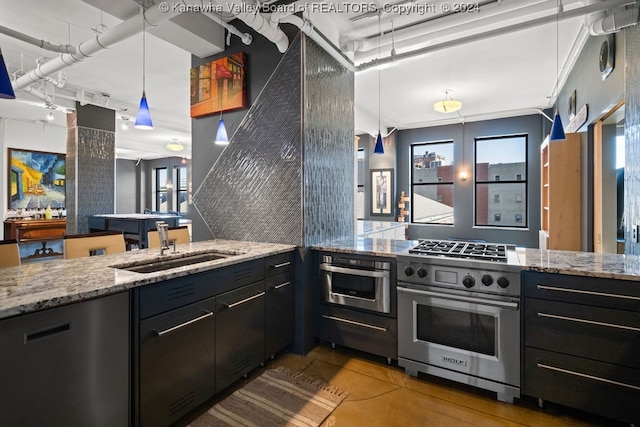 kitchen with crown molding, light stone countertops, decorative light fixtures, and oven