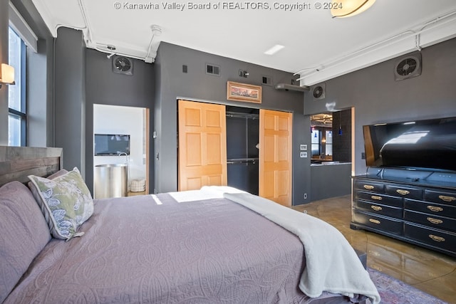 bedroom featuring tile patterned floors and a closet