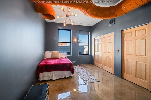 bedroom featuring a notable chandelier and a closet