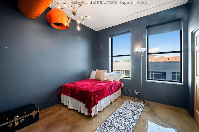 bedroom with a notable chandelier