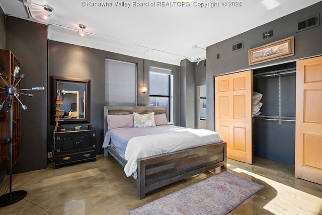 bedroom with a closet and concrete flooring