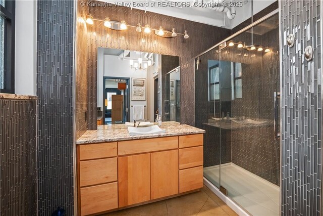 109 Capitol St Unit 400, Charleston, WV 25301 - full bathroom with vanity, tile patterned floors, an inviting chandelier, and a stall shower