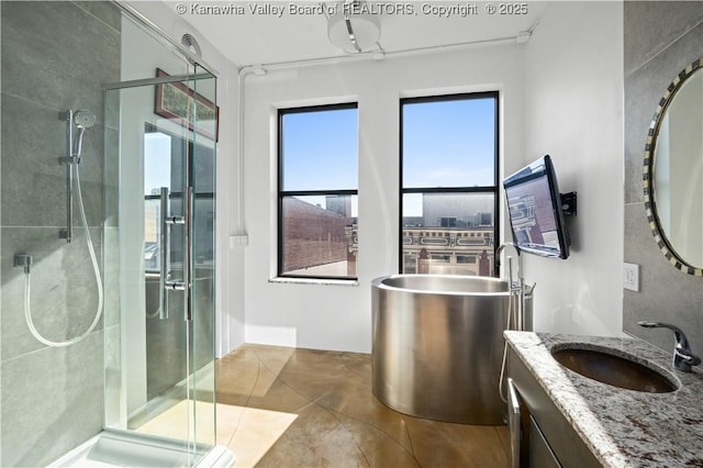 109 Capitol St Unit 400, Charleston, WV 25301 - full bathroom with vanity, a freestanding tub, tile patterned flooring, and a stall shower