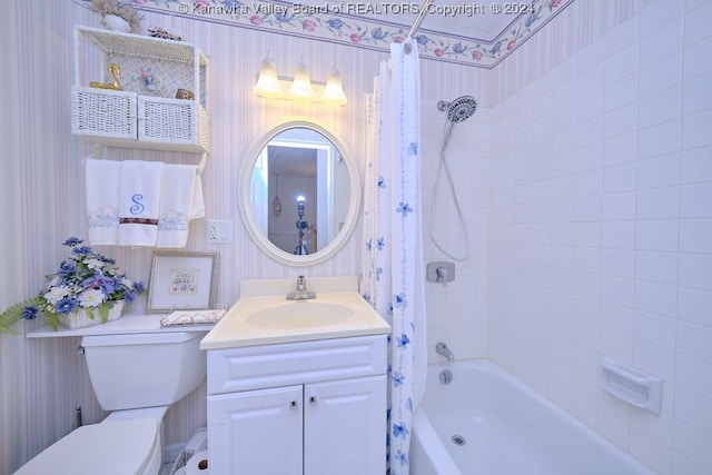 full bathroom featuring vanity, shower / bath combo, and toilet