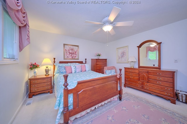 bedroom with light colored carpet and ceiling fan