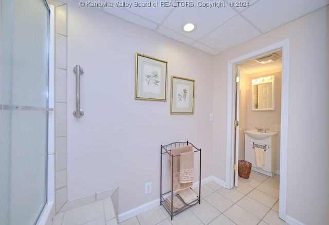 bathroom featuring vanity, a paneled ceiling, and tile patterned floors