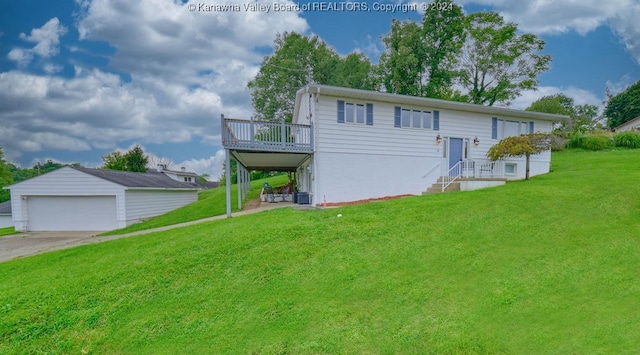 view of front facade featuring a garage, a front lawn, and an outbuilding