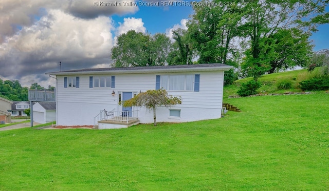 back of house with a yard and a garage