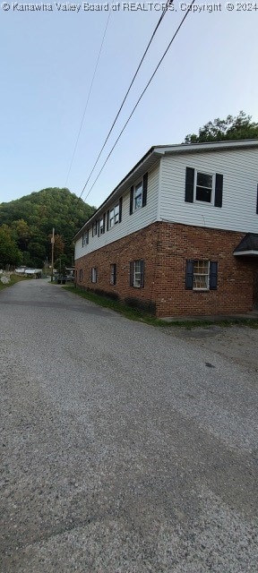 view of property exterior with a mountain view