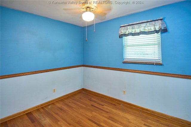 empty room with hardwood / wood-style flooring and ceiling fan