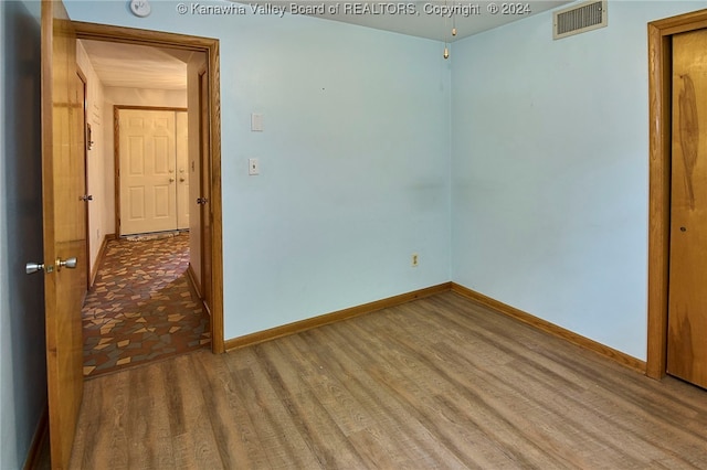 empty room with wood-type flooring