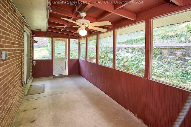 unfurnished sunroom with a wealth of natural light and ceiling fan