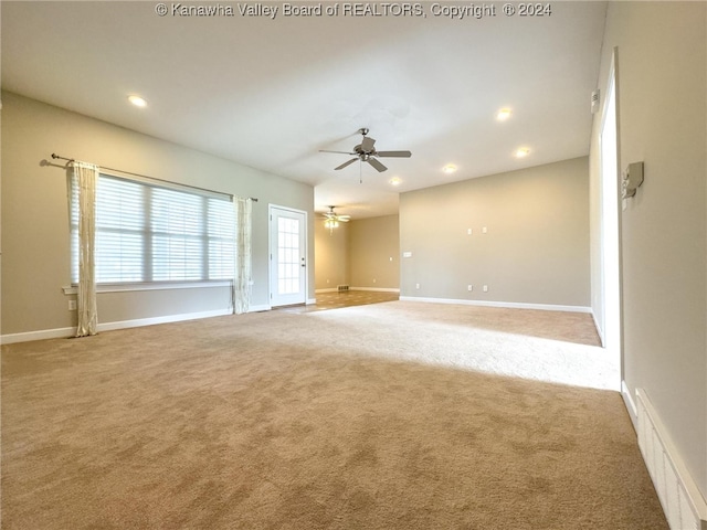 carpeted empty room with ceiling fan