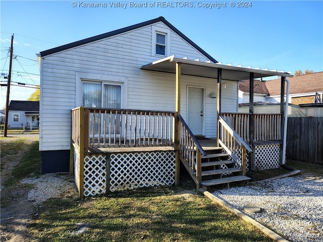 back of house featuring a wooden deck