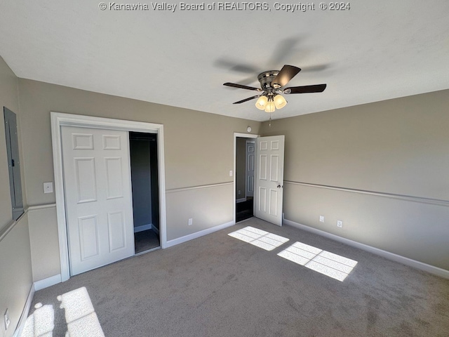 unfurnished bedroom with a closet, carpet, and ceiling fan