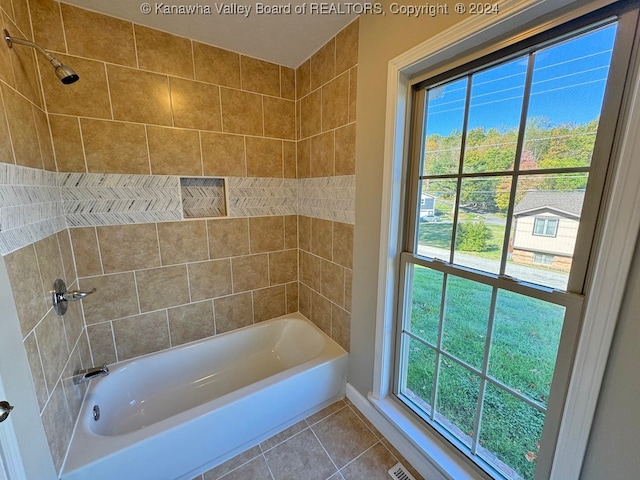 bathroom featuring tile patterned floors and tiled shower / bath combo