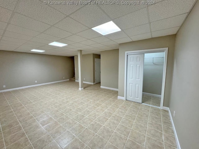 basement featuring a paneled ceiling