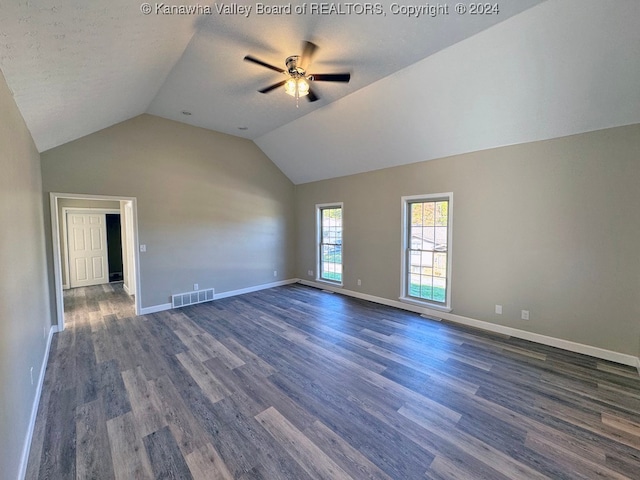 unfurnished living room with dark wood-type flooring, ceiling fan, and lofted ceiling