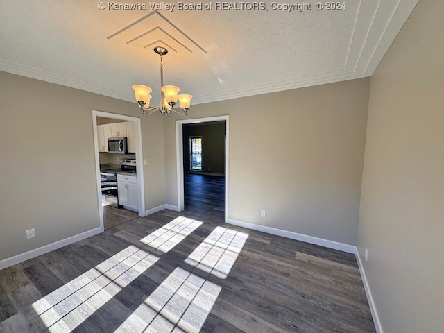 unfurnished dining area with ornamental molding, an inviting chandelier, a textured ceiling, and dark wood-type flooring