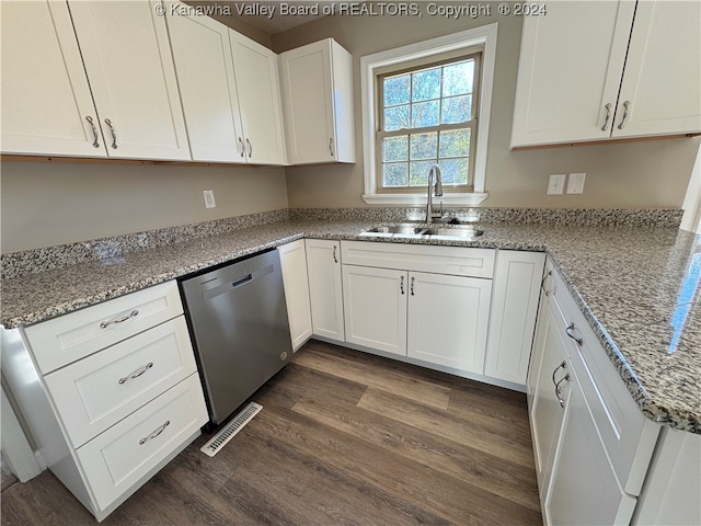 kitchen with light stone countertops, sink, dark hardwood / wood-style flooring, stainless steel dishwasher, and white cabinets