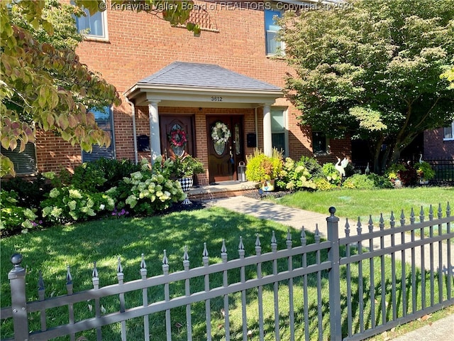 view of exterior entry with a lawn