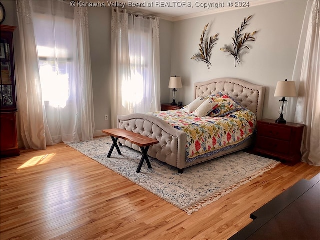 bedroom featuring crown molding and hardwood / wood-style flooring