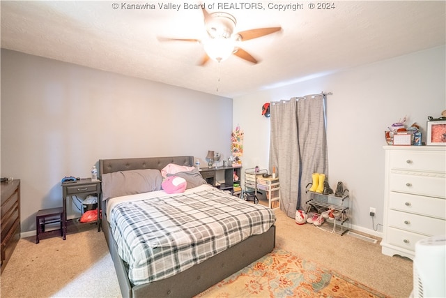 bedroom featuring light colored carpet and ceiling fan