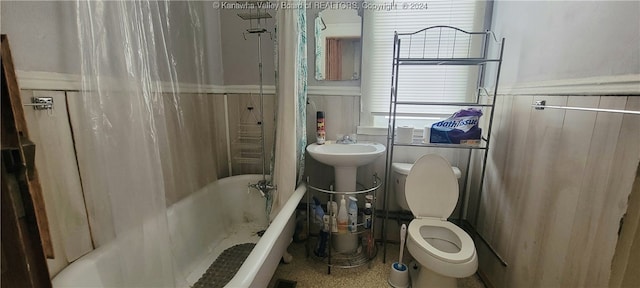 bathroom featuring toilet and shower / tub combo with curtain