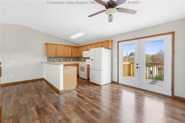 kitchen with white appliances, french doors, kitchen peninsula, and dark wood-type flooring